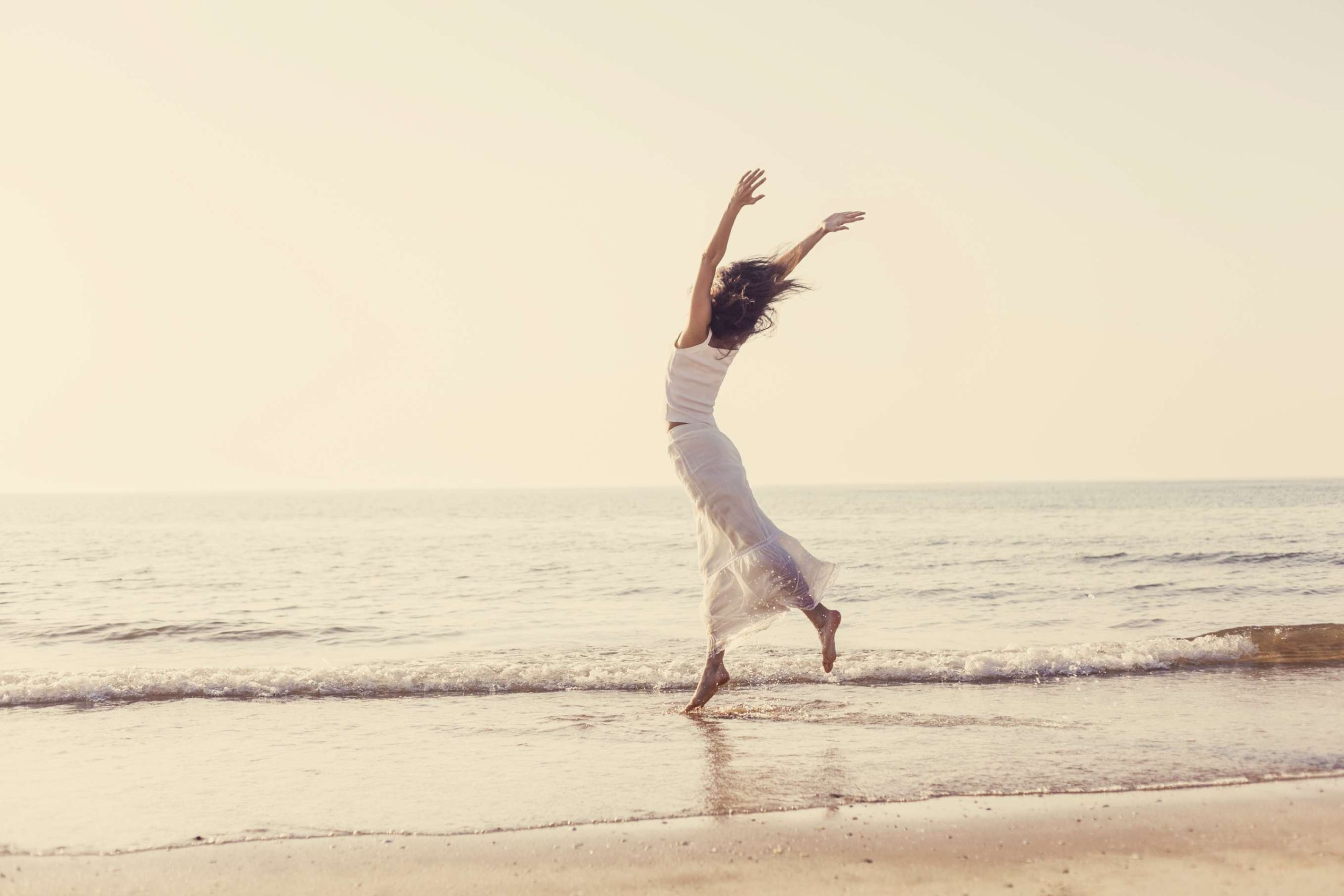 Young Woman Dancing On Beach