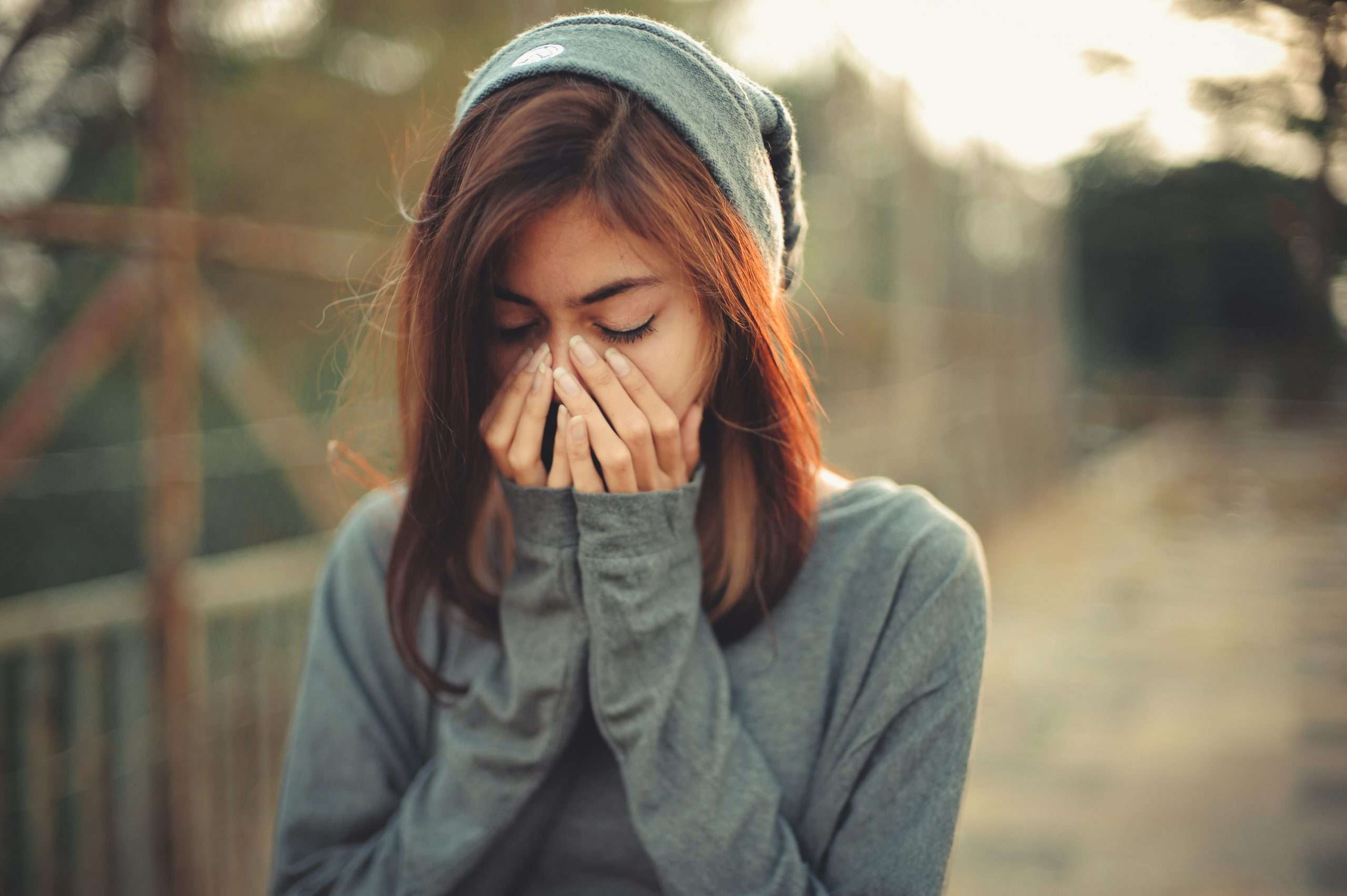 Teen with face in her hands